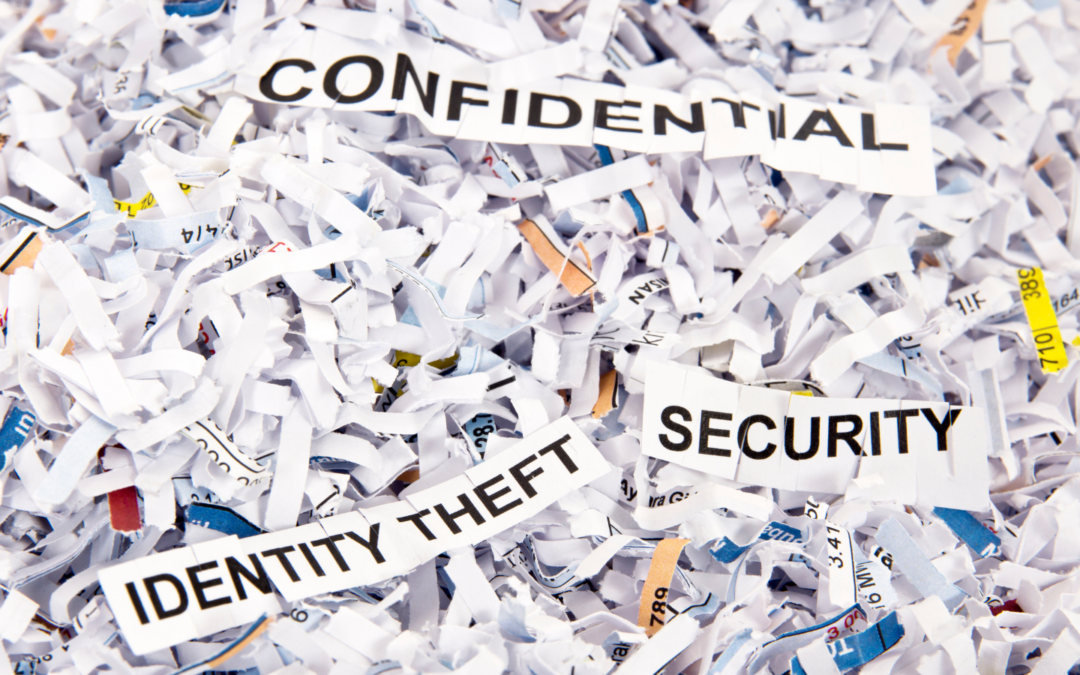 shredded paper with 3 pieces reading confidential security and identity theft at top